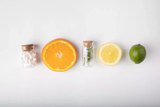 citrus fruits lined up with medicines in a bottle